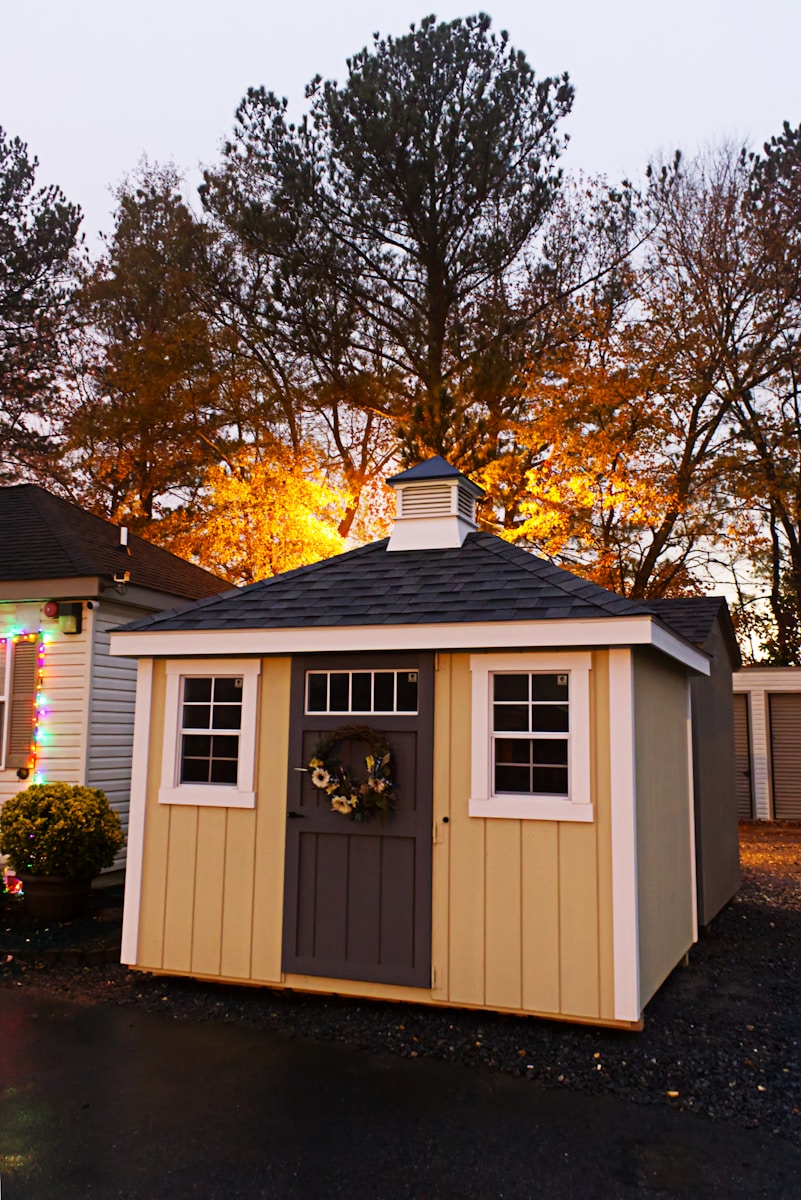 A small shed with lights on the side of it